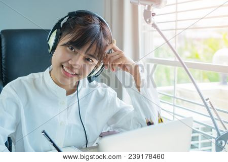 Education E-learning Foreign Languages Concept : Asian Student Young Man Wearing Headphones Listenin