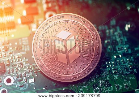 Shiny Copper Bancor Cryptocurrency Coin On Blurry Motherboard Background Token