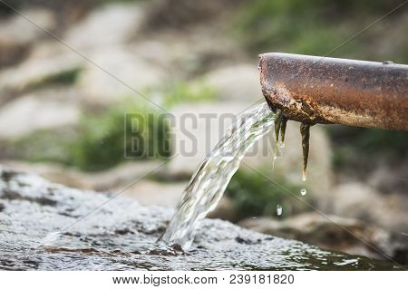 Draining The Water From The Rusted Drainpipe