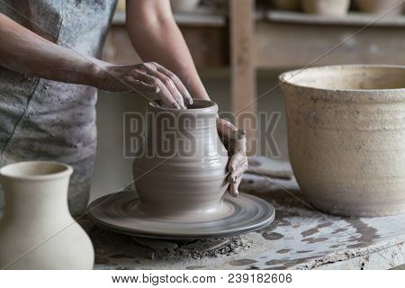 Potter Sculpts A Vase On A Potter's Wheel