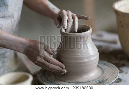 Potter Sculpts A Vase On A Potter's Wheel