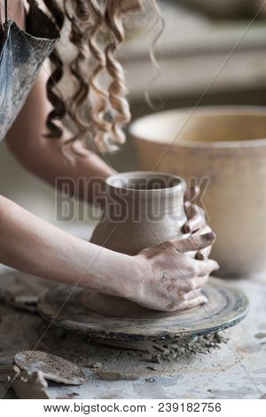Potter Sculpts A Vase On A Potter's Wheel