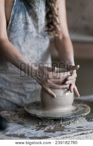 Potter Sculpts A Vase On A Potter's Wheel