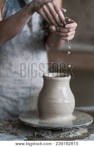 Potter Sculpts A Vase On A Potter's Wheel
