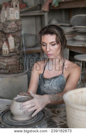 Potter Sculpts A Vase On A Potter's Wheel