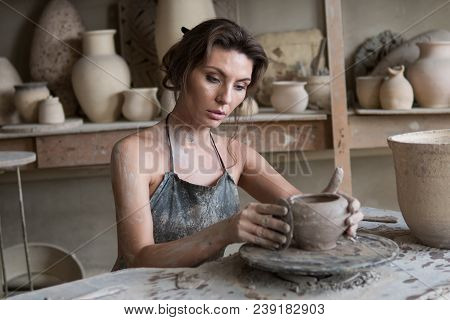 Potter Sculpts A Vase On A Potter's Wheel
