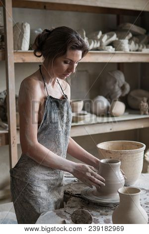 Potter Sculpts A Vase On A Potter's Wheel