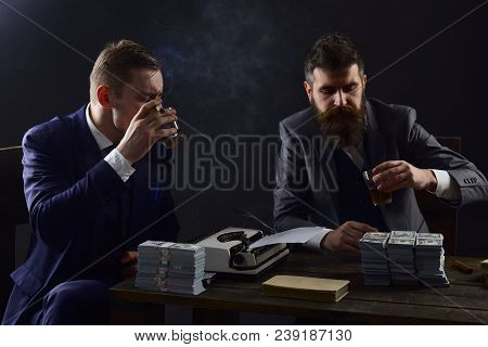 Illegal Business Concept. Company Engaged In Illegal Business. Men Sitting At Table With Piles Of Mo