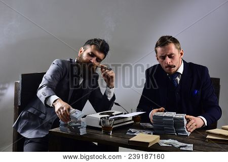 Company Engaged In Illegal Business. Businessmen Discussing Illegal Deal While Drinking And Smoking,