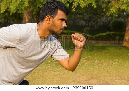 Close-up Of A Young Athlete In The Ready Position Before Going For A Run