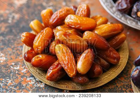 Close Up Of Of Dried Dates Or Kurma In A Vintage Plate.