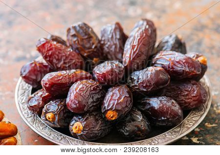 Close Up Of Medjoul - Dried Dates Or Kurma In A Vintage Plate.