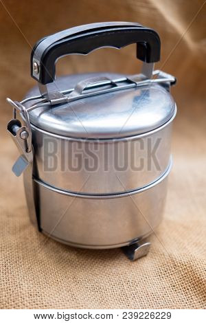 Stainless Food Carrier On Sacking Cloth Background