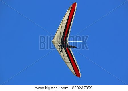 Hang Glider Flying In A Blue Sky