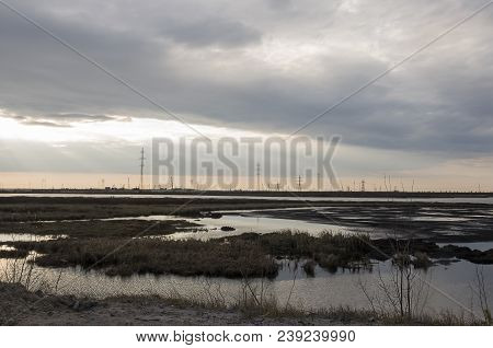 Late At Night. Sundown And Sunrises. River Running Across The Field With Reflections In The Water. E