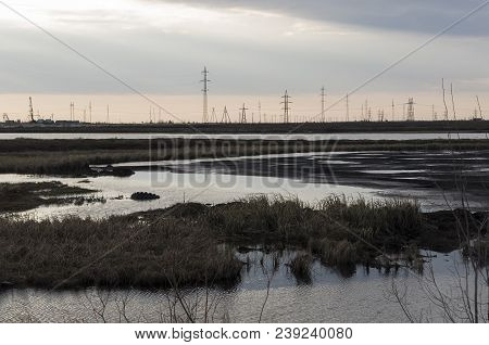 Late At Night. Sundown And Sunrises. River Running Across The Field With Reflections In The Water. E