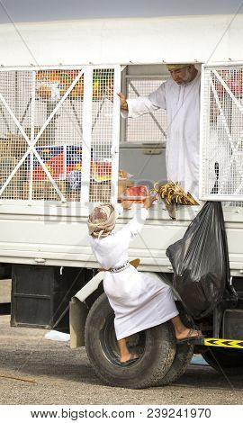 Ibri, Oman, 28th April 2018: Young Omani Boy At A Mobile Shop Trying To Reach