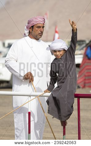 Ibri, Oman, 28th April 2018: Omani Kid At The Races With His Dad