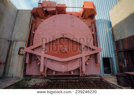 Red Metal Hermetic Gateway Door Of Airlock Of Nuclear Reactor Of Abandoned Unfinished Power Unit Of 