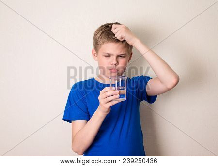 Boy Observing A Half Full Glass Of Water