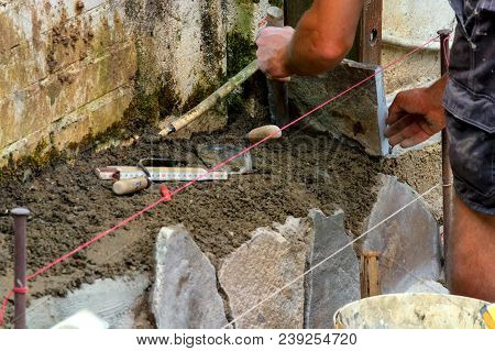 Workers At The Laying And Clipping Of Natural Stone Plates