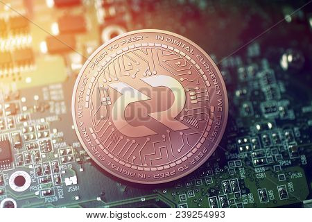 Shiny Copper Decred Cryptocurrency Coin On Blurry Motherboard Background Token
