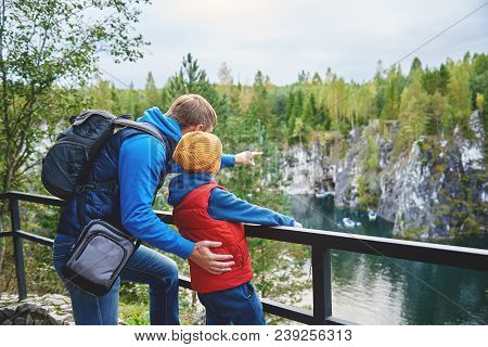 Father Showing Son Beautiful Lake View At A Canyon.