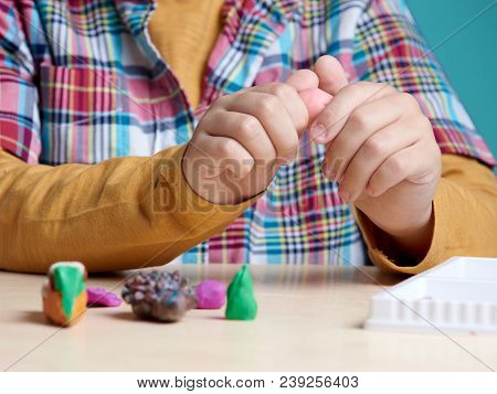 Boy Is Sculpting With Colorful Modelling Clay. Close Up.