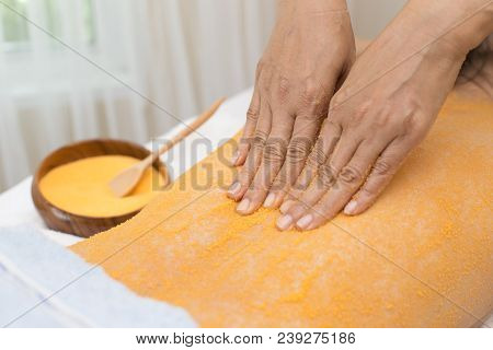 Woman Getting A Turmeric Massage At Spa Salon, Health And Healing Concept.
