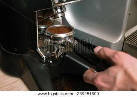 Roasted Arabica Or Robusta Coffee Beans Are Being Ground At A Cafe Or Bar In A Mill. Fresh Aromatic 