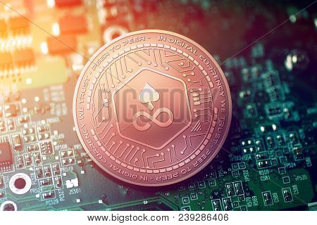 Shiny Copper Edgeless Cryptocurrency Coin On Blurry Motherboard Background Token