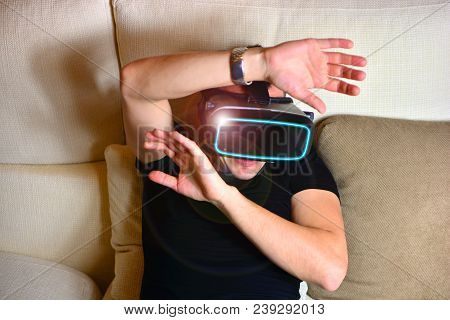 Virtual Reality. Man In A Vr Glasses Shoked By What He Sees With The Help Of Innovative Nano Technol