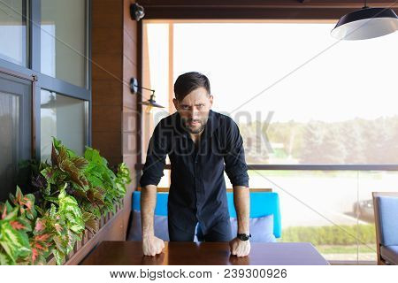 Young Male Manager Standing At Office And Wearing Black Shirt. Concept Of Responsibility And Success
