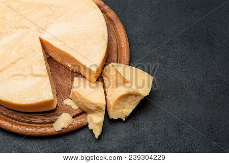 Whole Round Head And Pieces Of Parmesan Or Parmigiano Hard Cheese