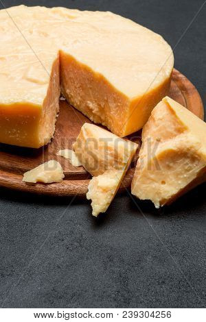 Whole Round Head And Pieces Of Parmesan Or Parmigiano Hard Cheese