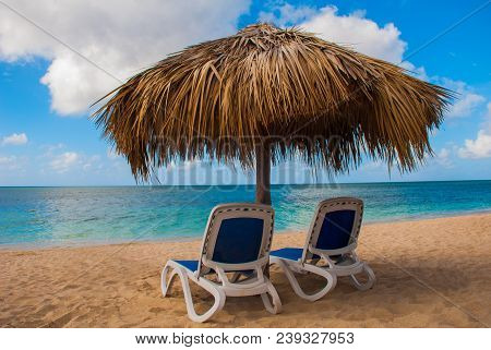 Sun Loungers And Parasols At The Paradise Beach. Cuba. Trinidad. Beautiful Tropical Ancona Beach. Ca