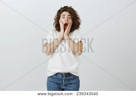 Girl Shocked To See Her New Haircut For First Time. Portrait Of Good-looking Surprised Young Woman W