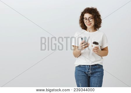 Attractive Hipster Girl Cannot Imagine Life Without Smartphone And Coffee. Carefree Successful Curly