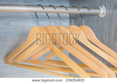 Wooden Coat Hangers On Metal Hager In Wardrobe