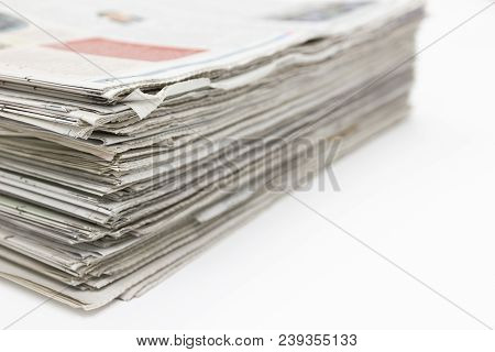 Closeup - Newspaper Stack On White Table In Work Office