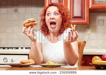 Big Woman Eat Fast Food. Red Hair Fat Girl With Burger, Potato And Fruit. Unhealthy Food Concept Wit