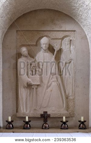 MUNSTERSCHWARZACH, GERMANY - JULY 09, 2017: Wurzburg bishop Adalbero, the savior of the monastery Egbert and the holy Makarius of Wurzburg, altar in Munsterschwarzach Abbey, Germany