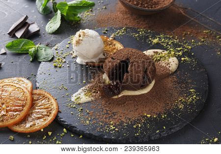 Classic French Dessert. Warm Chocolate Fondant Lava Cake With Custard And Vanilla Ice Cream On Slate