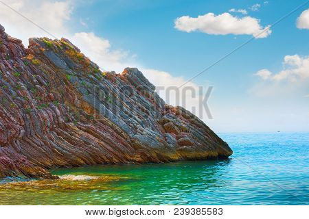 Scenic Layered Rocks In The Sea. Rafailovici. Montenegro. Beautiful Nature Horizontal Wallpaper