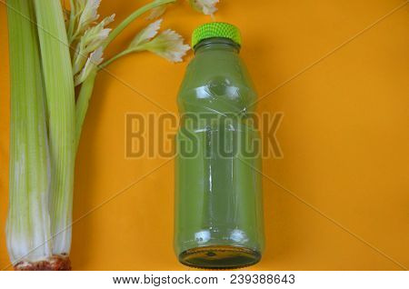 Healthy Detox Juice In Glass Bottles On Soft Orange Yellow Background. Colorful Bottles. Healthy Org