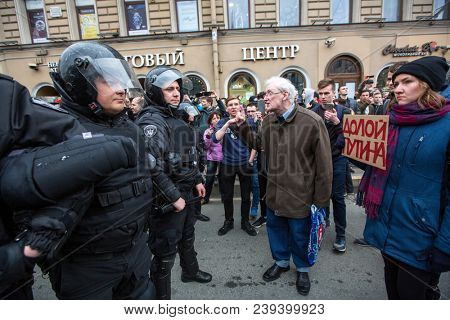 ST.PETERSBURG, RUSSIA - MAY 5, 2018: Police officers in riot gear block an Nevsky prospect during an opposition protest rally ahead of Vl.Putin's inauguration ceremony (Inscription: Putin remove )