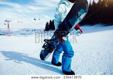 Closep Of One Snowboarder Snowboarding In Winter Mountains