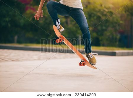 One Woman Skateboarder Sakteboarding On Parking Lot