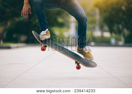 One Woman Skateboarder Sakteboarding On Parking Lot