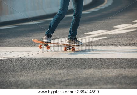 One Young Female Skateboarder Sakteboarding On Highway